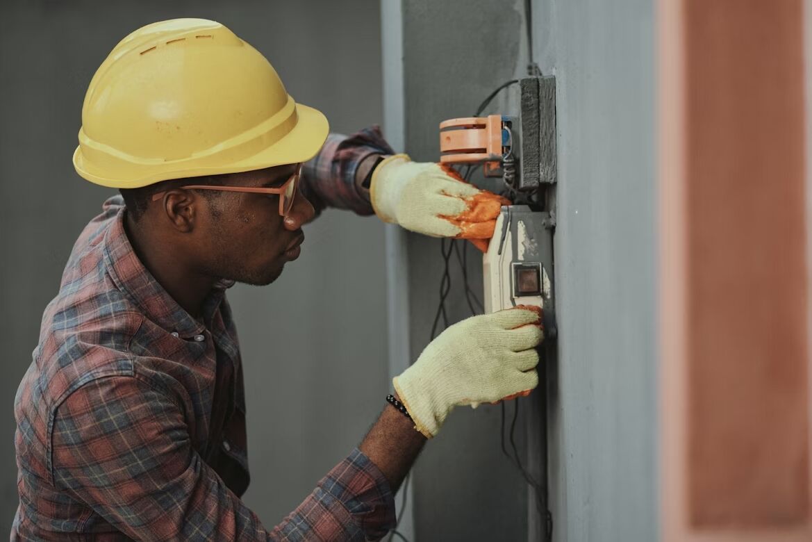 A man with a hard hat doing home repairs